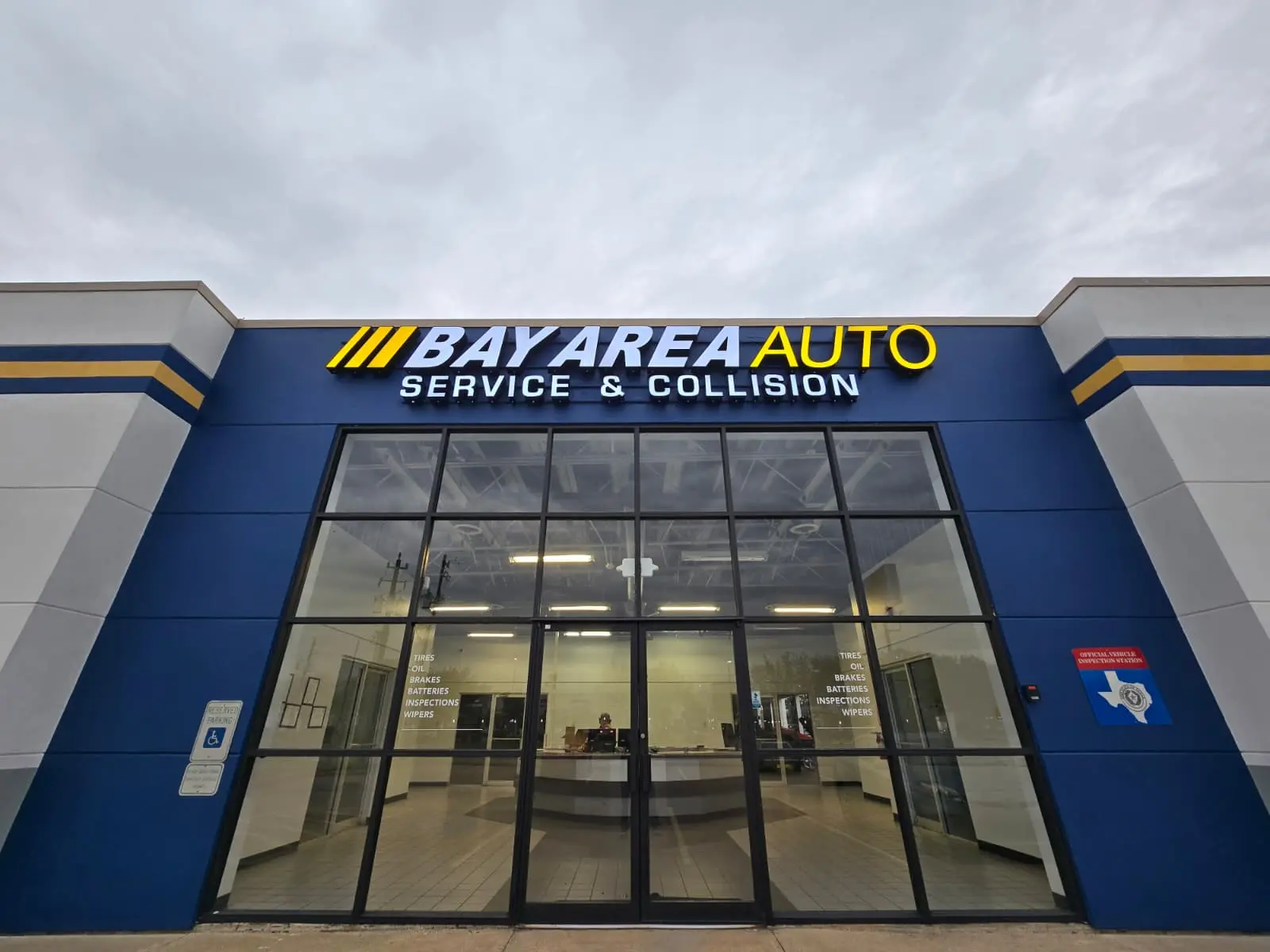 Bay Area Auto repair shop storefront with blue architectural panelling and glass entrance